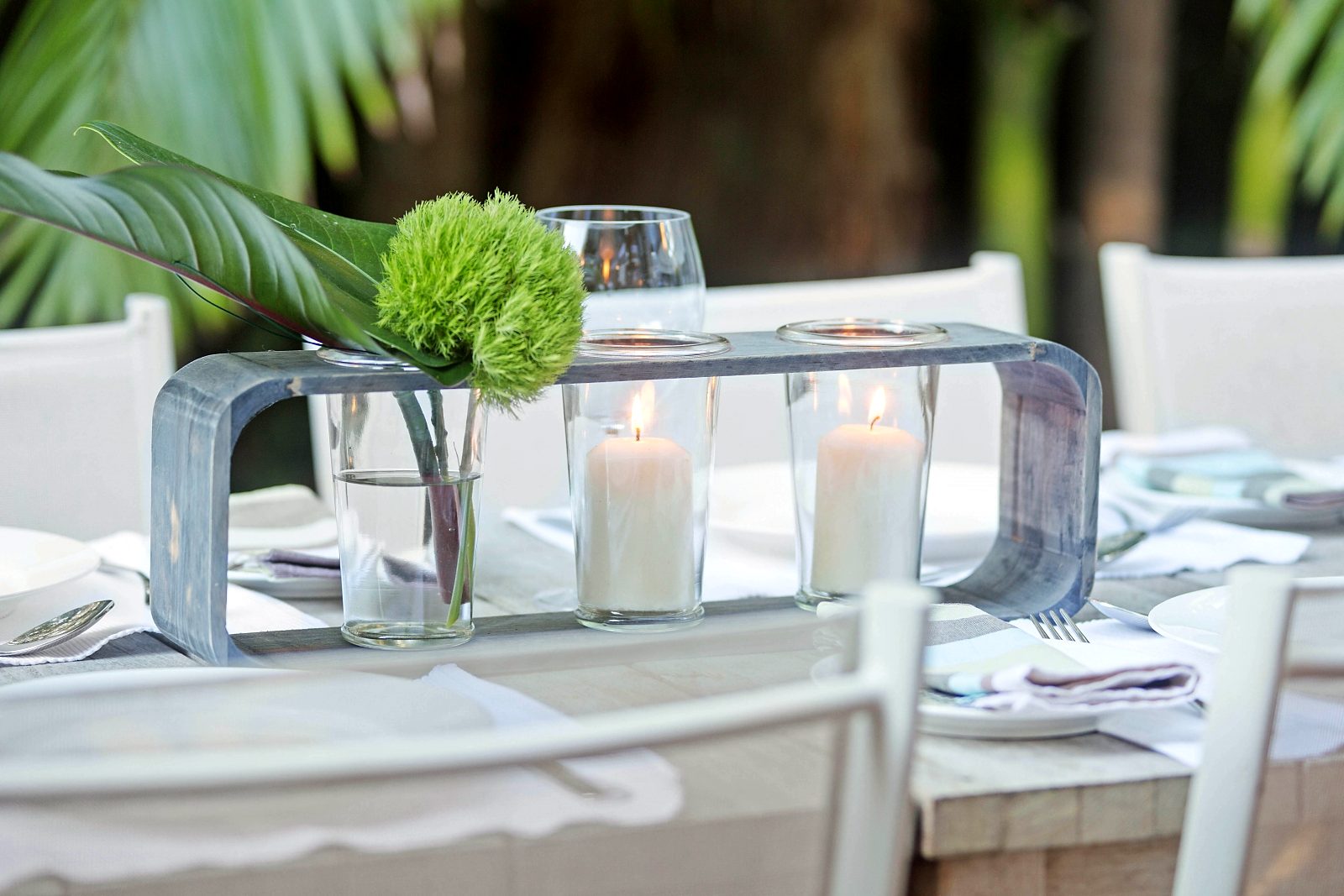 The outdoor table set for dinner on the deck at Sails Pearl Beach